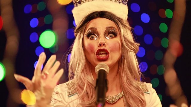 Video clip young woman singer in a New Year&rsquo;s costume Snow Maiden sings a song in stage light