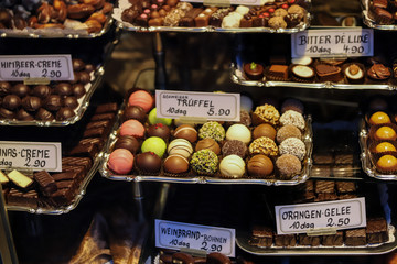 Truffles and chocolates in silver trays of different colors and flavors of the typical shops of Vienna, Austria.