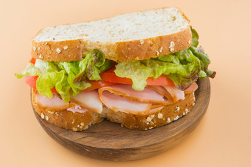 Sandwich of tomato, lettuce and smoked turkey
