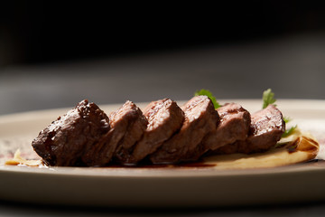 Filet mignon with mashed potatoes and pomegranate sauce, close-up