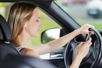Fototapeta na wymiar woman driver using her phone