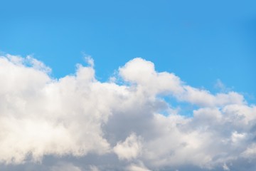 Beautiful white soft fluffy clouds on a blue sky background. Copy space