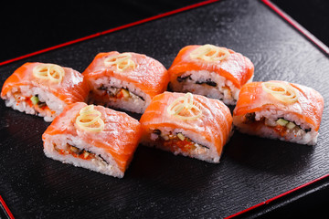 Japanese food, tasty of meal for lunch. Seafood. Sushi with eel, salmon, trout, tuna black background.