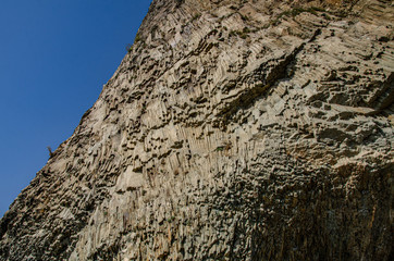 Mountain landscape, large cliffs by the sea, beach, sunny day.