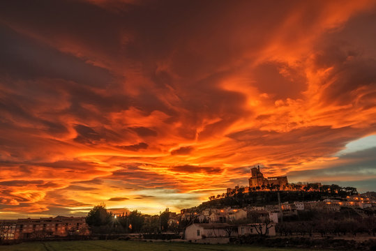 Spectacular sunset with lenticular clouds above a medieval castle in Caravaca de la Cruz, province of Murcia. Spain