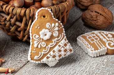 Fototapeta na wymiar Christmas gingerbread cookie in the shape of a bell, with nuts
