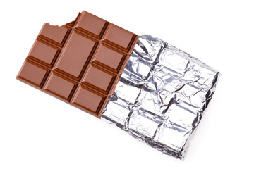bitten milk chocolate bar in foil isolated on white background. top view