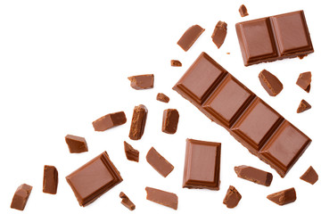 Milk chocolate pieces isolated on white background. top view