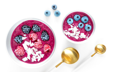 Organic breakfast berry Bowl with Blueberry, Raspberry, Currant and Coconut granola in plate, golden spoon isolated on white backgtound. Healthy Lifestyle concept.