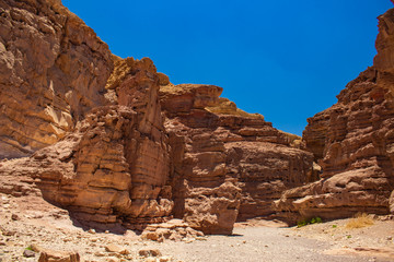 Negev Israeli desert dry ground sand stone rocky trail passage global warming landscape scenic view in bright clear weather day time without people