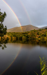 double rainbow over lake
