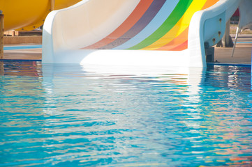 Fototapeta na wymiar Warer slide fragment and pool with blue water.
