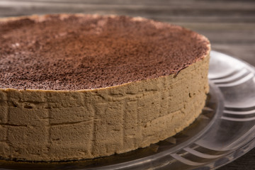 close-up of tiramisu cake with chocolate powder on a rustic table table