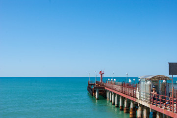 Fototapeta premium Beautiful white embankment on the Black Sea in Sochi, Loo. A pier with beautiful round lights. Calm sea, calm. Summer. Caucasus, subtropics