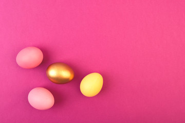 Easter eggs on pink background. Copyspace. Flat lay.