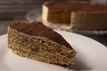 close-up of tiramisu cake with chocolate powder on a rustic table table