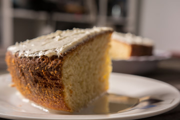 biscuit cake with vanilla cream close-up on a rustic table