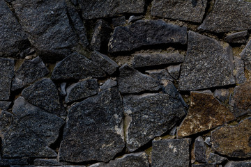 fence of black stones of irregular shape