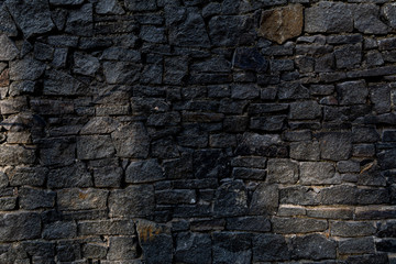 fence of black stones of irregular shape