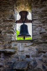 Obraz premium Bell in the bell tower of Church of San Juan at Hospital da Condesa in Province of Lugo, Galicia, Spain on the Way of St. James, Camino de Santiago