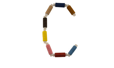 Isolated Font English or Latin or Russian letter C colorful spools of thread for sewing on white...