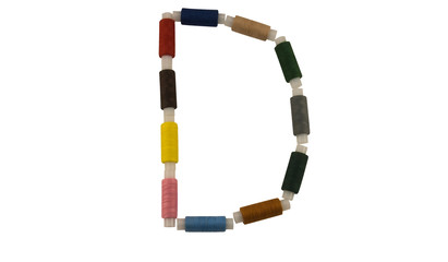 Isolated Font English or Latin Letter D made of colorful spools of thread for sewing on white background