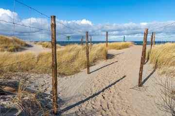 Path leading to the sea beach. Trail marked out by sea dunes.