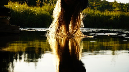 Fototapeta na wymiar hanging hair reflecting in the water