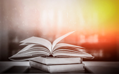 The concept of education by planting a tree of knowledge in the opening of an old book in the library and the magical magic of light that flies to the destination of success. Beautiful background