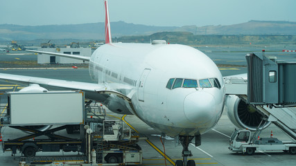 Beautiful new plane at the passenger airport. landing people in a white planes. Retractable...