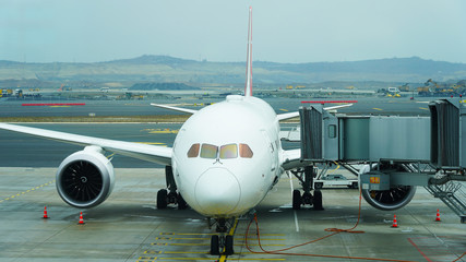 Beautiful new plane at the passenger airport. landing people in a white planes. Retractable...