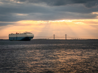 Obraz premium Cargo Ship by Bridge
