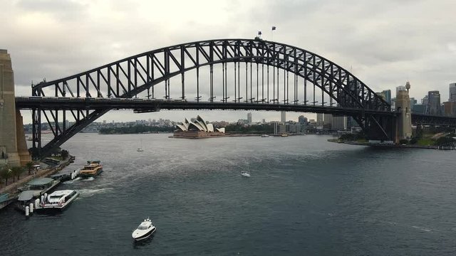Aerial footage of Sydney Harbour Bridge, from helicopter featuring Sydney CBD, Sydney Ferries (ferry), with Sydney Skyline in Background Ferries in Foreground, on the Parramatta River.