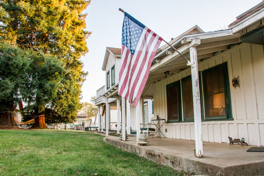 American Flag On Ranch House's Porch.