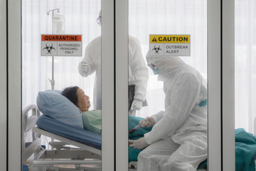 coronavirus covid-19 infected patient on bed in quarantine room with quarantine and outbreak alert...
