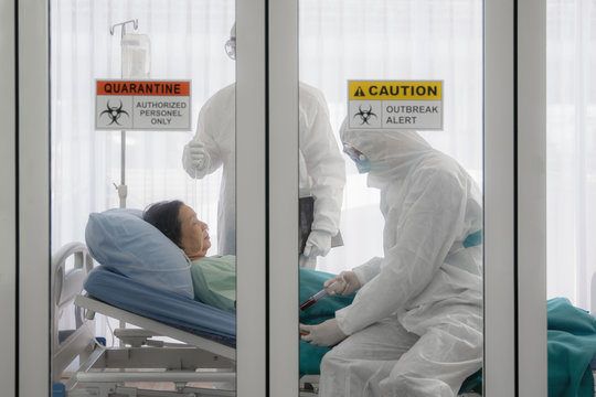 Coronavirus Covid-19 Infected Patient On Bed In Quarantine Room With Quarantine And Outbreak Alert Sign At Hospital With Disease Control Experts Make Disease Treatment, Coronavirus Outbreak Control