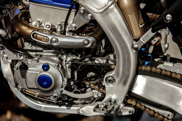 Obraz premium Details of a cross-country motorcycle. Motor sports. Spare parts. Lifestyle motorcycle. Motorcycle engine with gearbox, close up photo. 