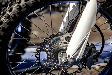 Fototapeta premium Close-up of the front wheel of a racing cross-country motorcycle. Lifestyle.