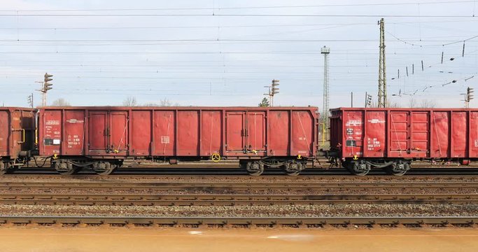 BUDAPEST, HUNGARY - CIRCA 2020: Freight train railway cargo wagons at a station, viewed from passing by train