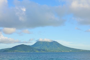 Fototapeta premium Day view of the Nevis Peak volcano across the water from St Kitts