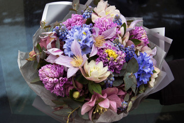 Beautiful elegant designer pink purple blue bouquet of florist with different flowers close-up....