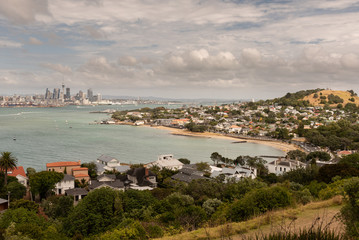 Fototapeta na wymiar The view from North Head over the beach at Torpedo Bay and Devonport, across the Waitemata Harbour to Auckland City and the port in the background.