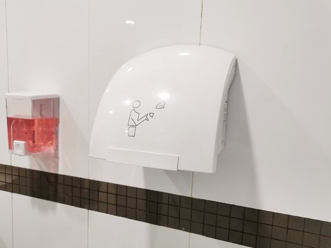 Hot Air Hand Dryer In The Public Toilet. Hygiene Concept.