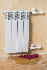 A red rag under a leaking radiator in a private home. Accident of the heating system of a private...