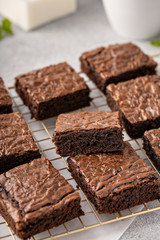 Homemade fudgy brownies freshly baked on a baking rack