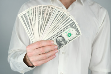 Man holds a lot of money. Concept of wealth, rich living, earning money online..