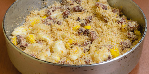 bacon farofa in the pan on the wooden table