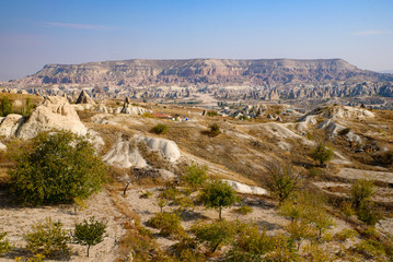 Fototapeta na wymiar Rock formations of mountain ridges, valleys and pinnacles at Göreme National Park, Cappadocia, Turkey