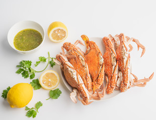 Cooked Steamed blue crab on white plate food concept background, top view.