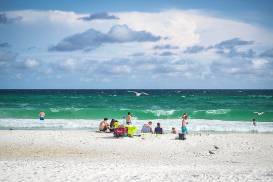 People hanging out at open spacious beach
